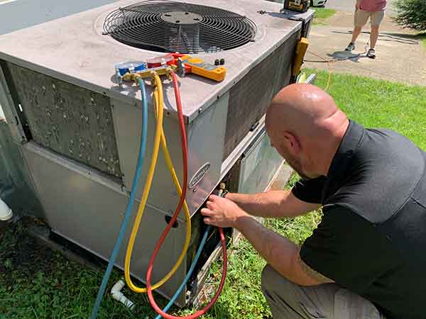 HVAC Technician Running Diagnostic Inspection on HVAC Unit