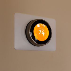 an orange smart thermostat that's set to 74 degrees