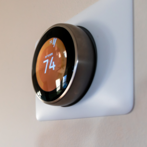 programmable thermostat with orange light set to 74