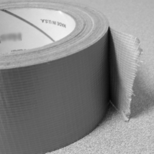 a close up shot of a roll of duct tape with a small piece unrolled