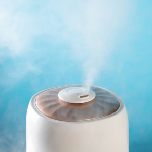 photo of humidifier misting in front of a blue background