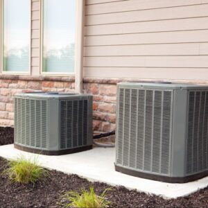two air conditioning units outside a home